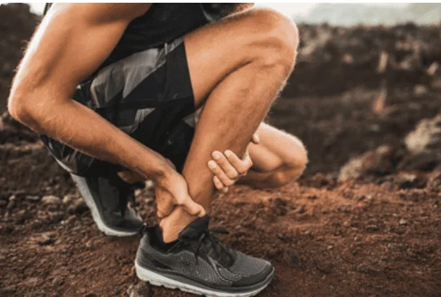 Man holding foot in pain - seeking foot pain relief.