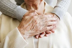 stock photo mature female in elderly care facility gets help from hospital personnel nurse senior woman aged 250nw 1805972035